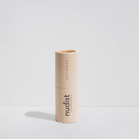 Beige lipstick with 'nudist' branding on a light gray background