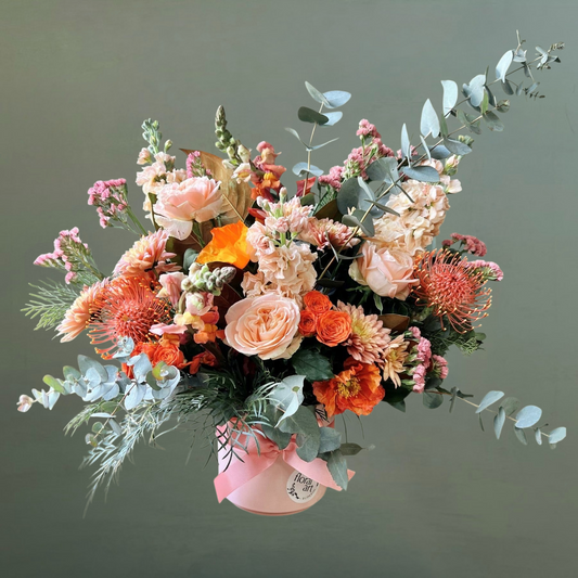 Bouquet of flowers in a pink vase on a plain background
