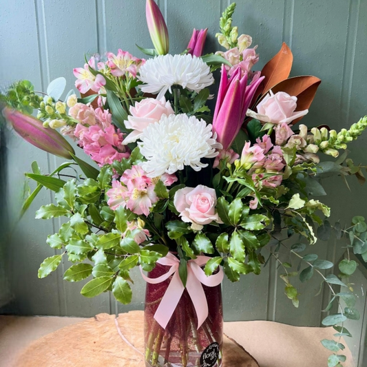 Big and tall vase full of pink and white flowers