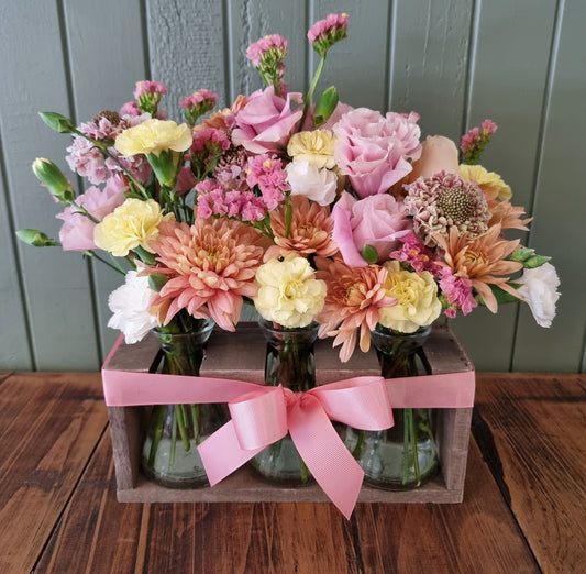 Trio of vases and stand full of seasonal flowers