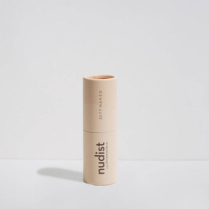 Beige lipstick with 'nudist' branding on a light gray background