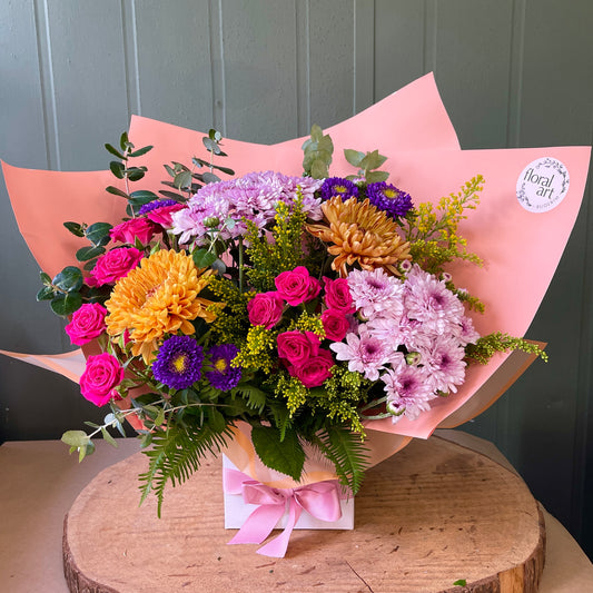 bright flowers arranged in a white box