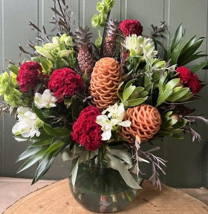 Christmas coloured mixed flowers in glass vase