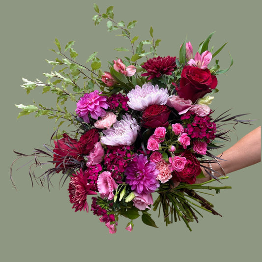 Bouquet of flowers held by a hand on a transparent background