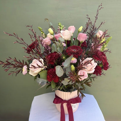Bouquet of flowers in a vase with a green background