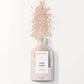 Bottle of 'Butt Naked' rose mask with a white label on a white background