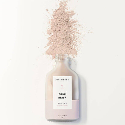 Bottle of 'Butt Naked' rose mask with a white label on a white background