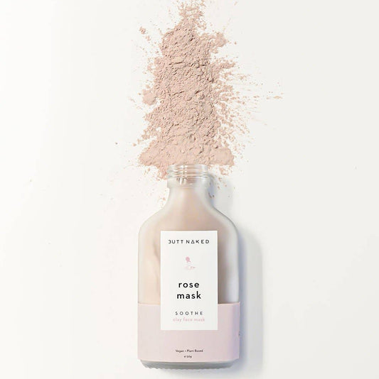 Bottle of 'Butt Naked' rose mask with a white label on a white background