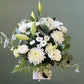 white flowers and greenery in white box