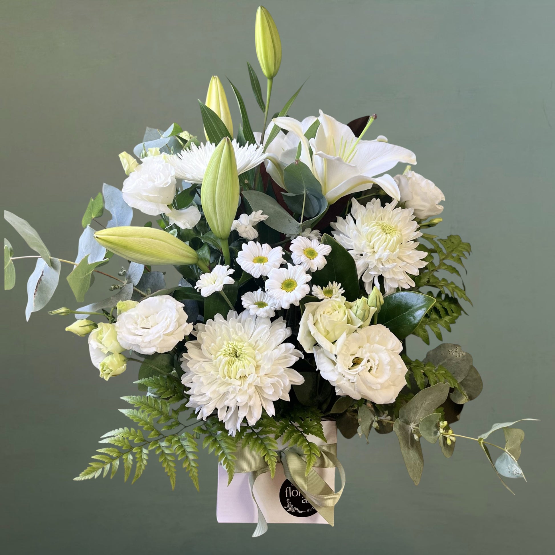 white flowers and greenery in white box