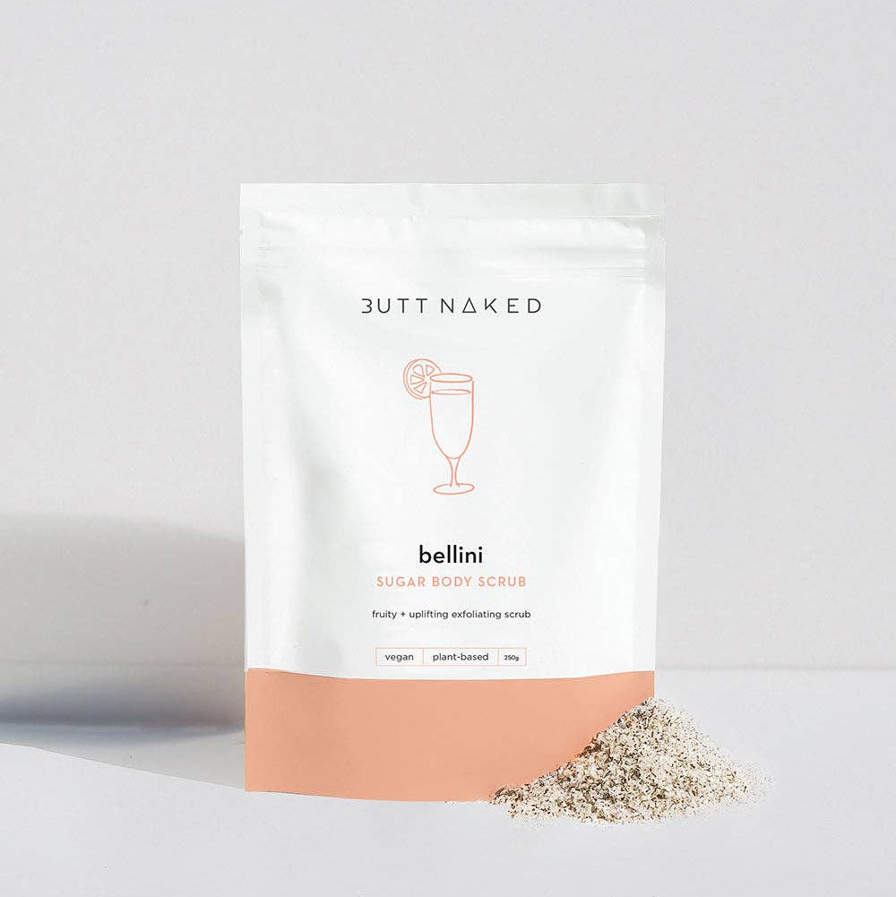 Butt Naked bellini sugar body scrub packaging on a light gray background