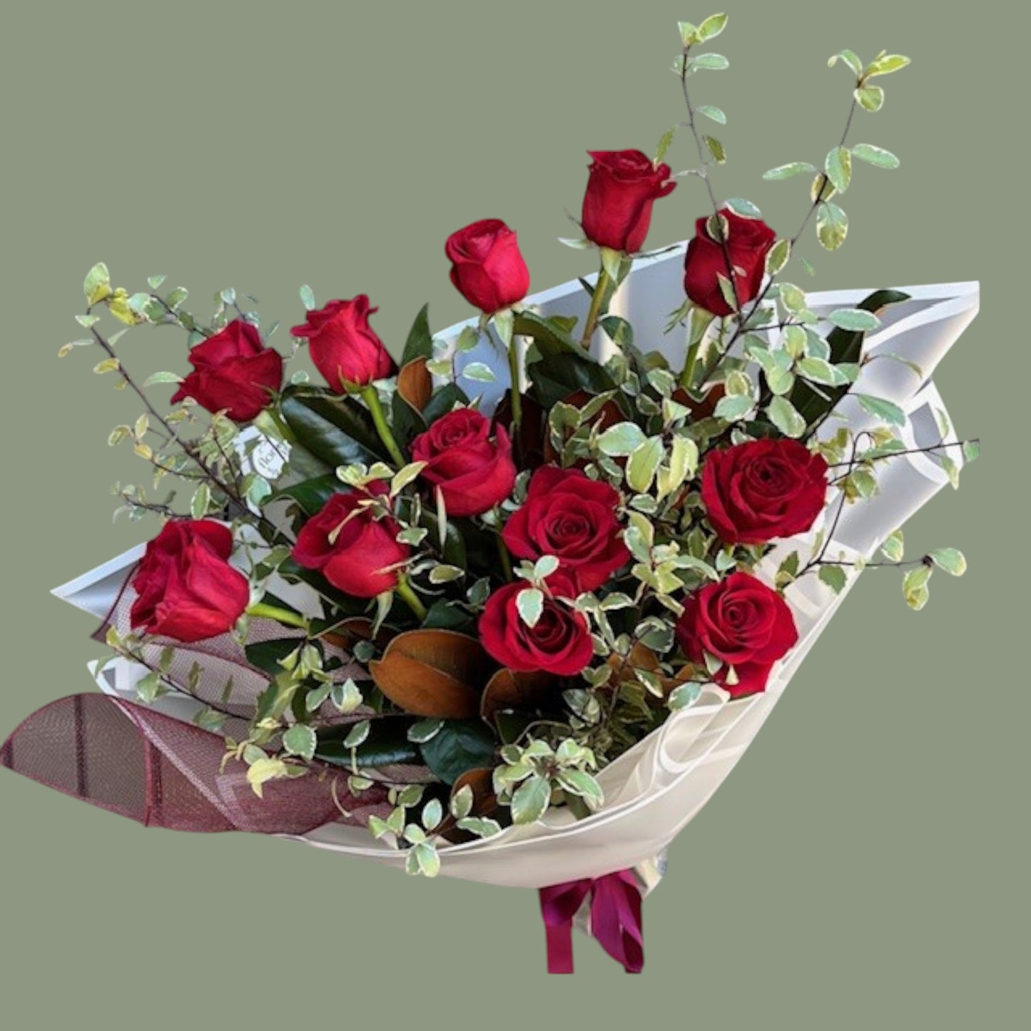 Bouquet of red roses with greenery on a gray background