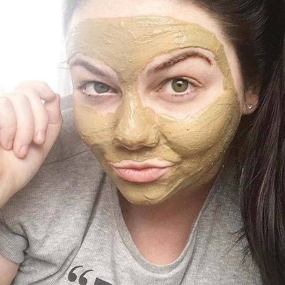 Person wearing a green facial mask with a neutral expression.