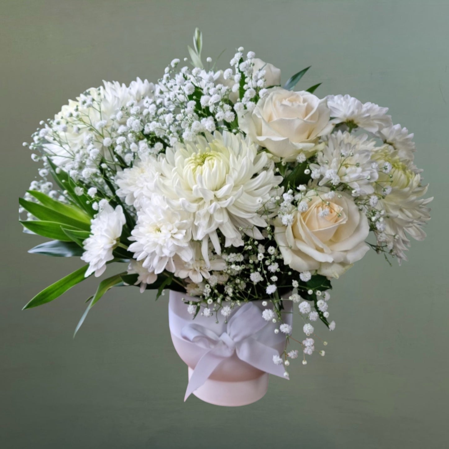 White flowers arranged in a white ceramic pot