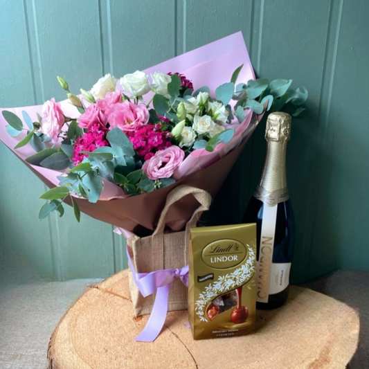 Flowers chocolate and Moet in gift bag