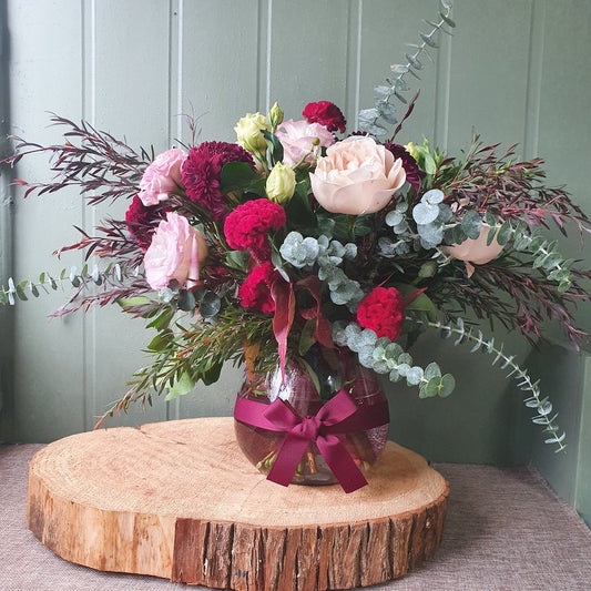 romantic flowers in fishbowl vase